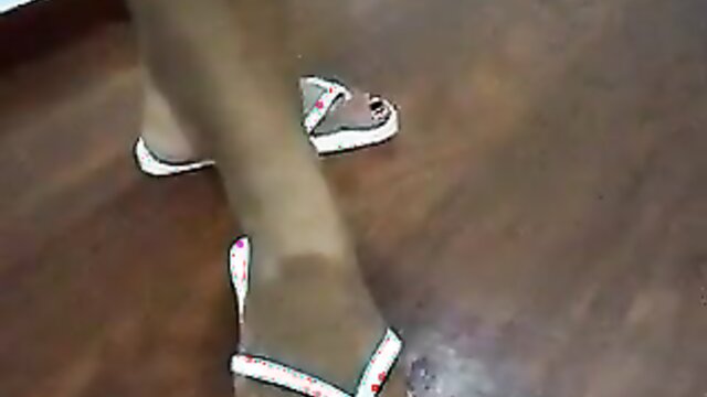 Latina feet in white flip flops