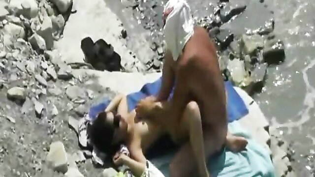 The ultimate voyeur experience: Watch as a MILF gets naughty on a beach