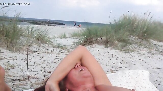 Girls masturbating in the nude on the beach